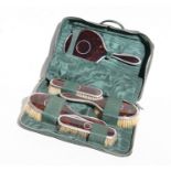 A Mappin & Webb silver and tortoiseshell travelling dressing table set comprising four brushes and a