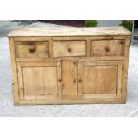A pine dresser base with three frieze drawers above two panelled doors. 150cm (59 ins) wideCondition