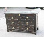 An 18th / 19th century oak mule chest, the hinged top above two dummy drawers with a further long