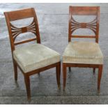 A pair of 19th century Biedermeier style side chairs with upholstered seats, on square tapering