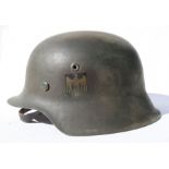 A WW2 Third Reich M1942 Wehrmacht helmet with liner and chin strap. Stamped inside: ET64 & 1087