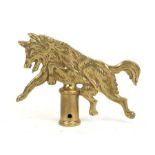 A Boy Scout Leaping Wolf brass flagpole finial, 14cms (5.5ins) high.