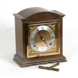 An Elliott of London mahogany cased mantle clock with silvered dial and Roman numerals, the movement