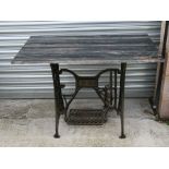A garden table, the Art Nouveau cast iron treadle sewing machine base with rectangular figured