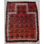 A prayer rug with repeated motifs within a multi border, 132 by 96.5cms (52 by 38ins).