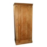 A pine single wardrobe with single panelled door, 85cms (33.5ins) wide.