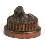 A Victorian copper jelly mould depicting a recumbent lion, cross and orb mark for Benham & Froud,