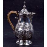 A continental silver coloured metal hot milk jug, crested, with embossed decoration, weight 153g,