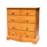 A modern pine chest of two short and three long drawers, a pair of matching bedside drawers and a