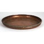 A Hugh Wallis Arts & Crafts beaten copper shallow bowl, 24cms (9.5ins) diameter.