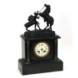 A Victorian black slate mantle clock surmounted with a spelter group depicting a rearing horse,