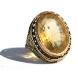 A citrine and yellow coloured metal ring, approx UK size 'N'.