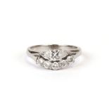 A platinum and diamond ring (tested) set with a Princess cut diamond flanked by two trillion cut