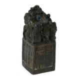 A Chinese bronze seal, the top with a mythical beast, on a square platform with character marks,