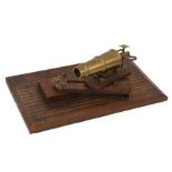 A bronze model of a cannon W. North. 1848, mounted on a wooden pivoting stand, overall 37cms (14.