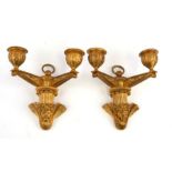 A pair of ormolu twin-arm wall sconces with cherub head decoration, each 12.5cm (5ins) wide (2).