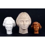 A plaster bust of a young ladies head, 20cms (8ins) high; together with two similar smaller (3)