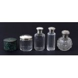 A silver topped scent bottle; together with three silver topped dressing table jars and a