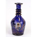A Bohemian blue glass decanter with enamel and gilt decoration, with printed portraits of Mozaffar