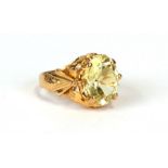 A Chinese yellow metal ring set with a large yellow stone, approx UK size 'K'. 5.4gCondition