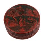 A Chinese red cinnabar box & cover of circular form, decorated with figures in a landscape, 16cms (