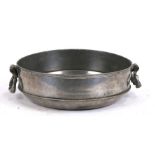 A French pewter two-handled bowl with touch marks to the underside, 28cms (11ins) diameter.