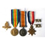 A WW1 RFA & RA medal trio named to 65235 Driver AA Macey together with associated brass badges