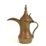 A large Turkish / Islamic brass dallah coffee pot with impressed mark. 37cm (14.5 ins) high
