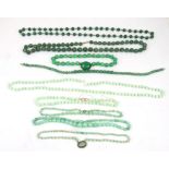 A jade like necklace and other similar necklaces.