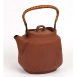 A Japanese pottery teapot, 22cms (8.75ins) high.