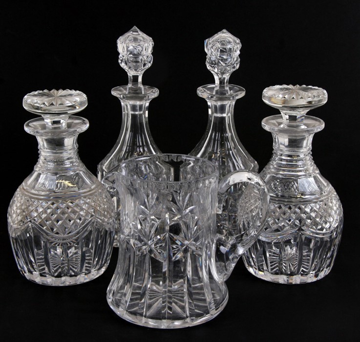 A pair of cut glass decanters and stoppers with hobnail cut decoration, 22cms (8.75ins) high another