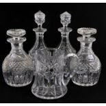 A pair of cut glass decanters and stoppers with hobnail cut decoration, 22cms (8.75ins) high another