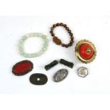 A Chinese cinnabar lacquer brooch, a tigers eye bracelet and other items.