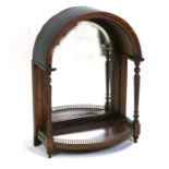 A Victorian rosewood dome topped mirrored back bracket with turned columns and brass gallery,