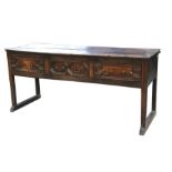 A late 18th / early 19th century oak dresser base with three frieze drawers and geometric moulded