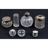 A group of silver topped dressing table items to include scent bottle and hair tidy.