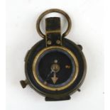 A WWI brass field compass, the reverse impressed FL Broad Arrow No. 77796 1917.