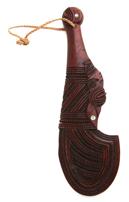 A 20th century Maori Wahaika war club with ornate carved geometric design and inset mother of