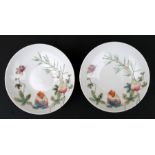 A pair of Chinese famille rose footed dishes decorated with fruit and butterflies, red seal mark