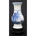 A Chinese blue & white baluster vase decorated with figures in a mountainous river landscape, on a