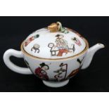 A Chinese famille rose teapot decorated with figures with gilded peach finial, a red seal mark to