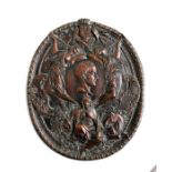 An oval copper plaque decorated in relief with angels playing horns, Britannia flanked by a lion and