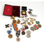 A quantity of enamel badges, medals and medallions.