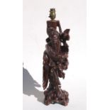 A Chinese rootwood figural carving table lamp in the form of a sage, 42cms (16.5ins).