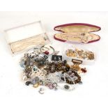 A quantity of costume jewellery to include necklaces, brooches and bangles.