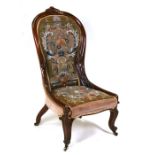A Victorian walnut nursing chair with upholstered beadwork seat and back.