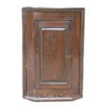 A 19th century oak corner cupboard with single panelled door, 60cms (23.5ins) wide.