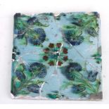 A large 17th century Islamic / Iznic tile decorated with flowers on a turquoise ground, 25 by