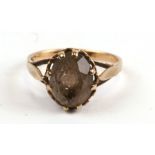 A 9ct gold ring set with an oval smoky quartz, approx UK size 'L'.