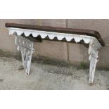 A Victorian cast iron wall mounted garden bracket or shelf with slatted top, 66cms (26ins) wide.